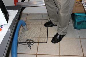 Technician Removing Water Out Of Flooded Home