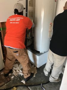 Repair Techs Fixing A Water Heater Burst